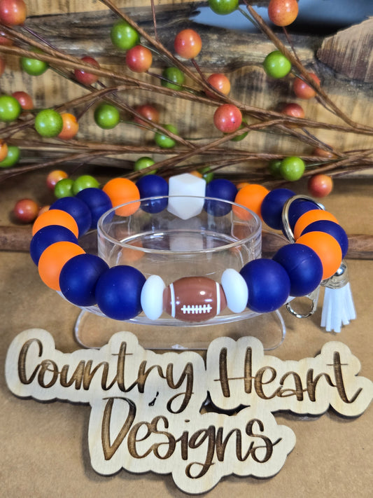 #918 UVA Inspired Wristlet 🏈😉  **1 𝑎𝑣𝑎𝑖𝑙𝑎𝑏𝑙𝑒 𝑚𝑎𝑑𝑒 𝑏𝑢𝑡 𝑡ℎ𝑖𝑠 𝑖𝑡𝑒𝑚 𝑤𝑖𝑙𝑙 𝑏𝑒 𝑟𝑒𝑠𝑡𝑜𝑐𝑘𝑒𝑑/𝑚𝑎𝑑𝑒 𝑎𝑠 𝑖𝑡 𝑠𝑒𝑙𝑙𝑠 𝑜𝑢𝑡!!